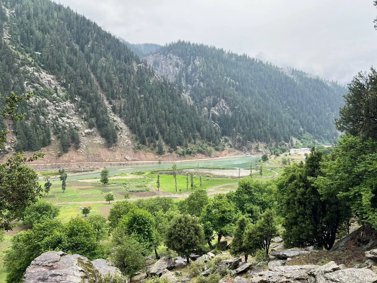 Natural scenery of Nuristan Province in eastern Afghanistan, showing forested mountains, rivers, and traditional villages in a remote landscape.